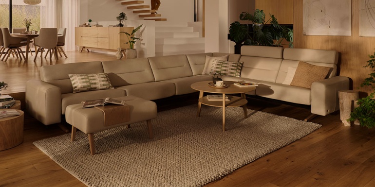 Modern beige corner sofa in a warm, contemporary open-plan living room